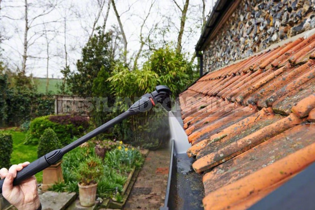 Cleaning The Drains Of a Country House From Leaves And Other Debris